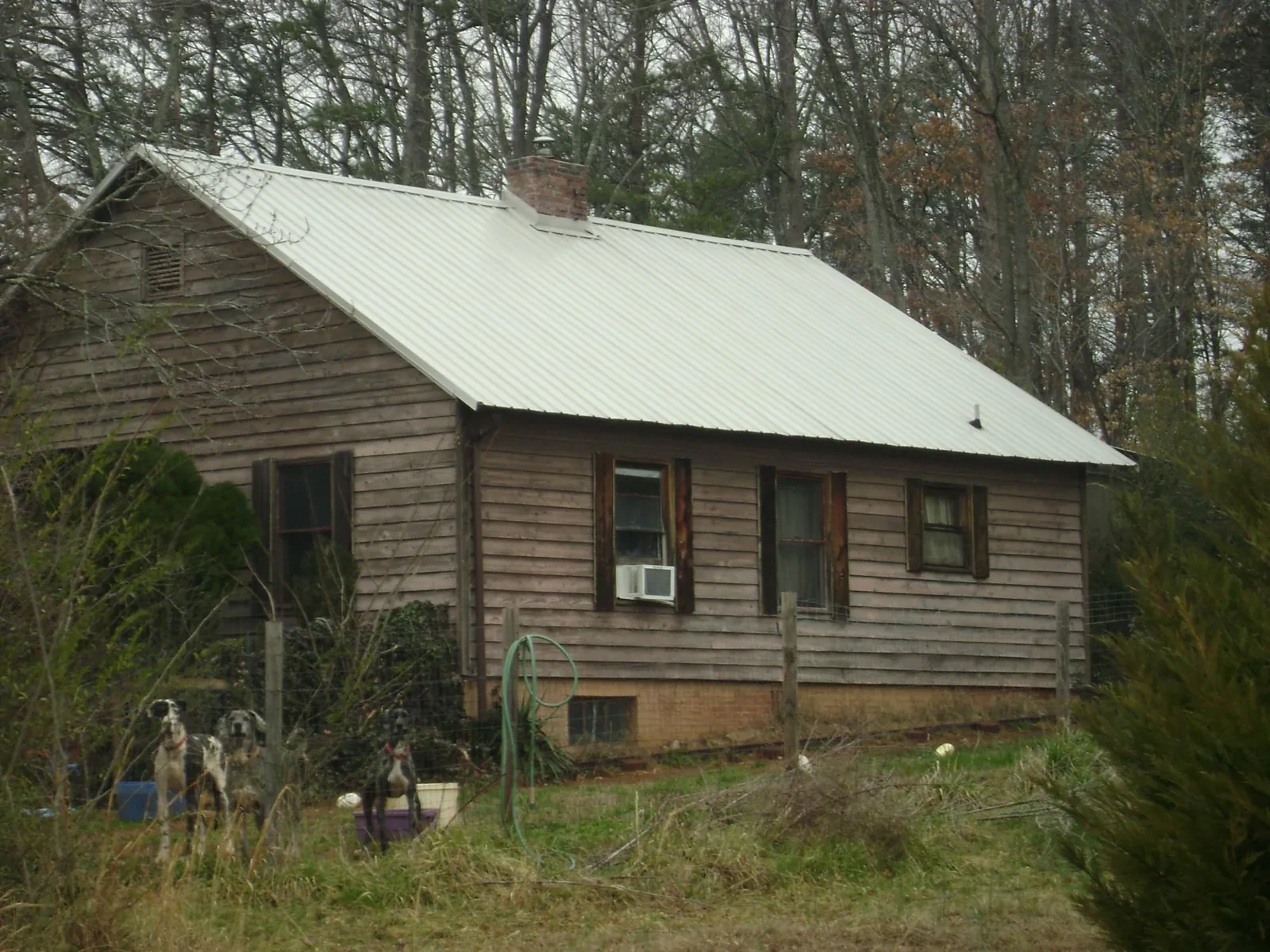 White metal roof on an old wood sided farmhouse, from a Metal Roof Installation job in Newburg